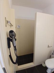 a phone in a bathroom with a toilet at Sails1 in Agia Eleousa