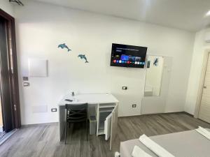 a room with a desk and a tv on the wall at Blue Cave b&b in Palinuro