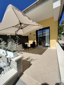 a patio with a large umbrella and chairs at Blue Cave b&b in Palinuro