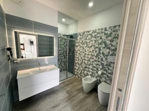 a bathroom with a sink and a toilet and a mirror at Blue Cave b&b in Palinuro