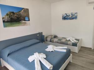 a bedroom with two beds with towels on them at Blue Cave b&b in Palinuro