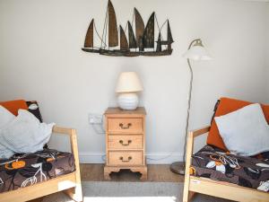 a room with two beds and a table with a lamp at Rivers View - Uk49662 in Braunton +7 photos