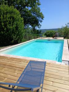 a swimming pool with a chaise lounge and a chair at Jardin sur Loire in Blois