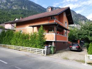 a house on the side of a road with a fence at The Nook Apartment in Jesenice