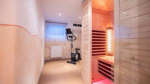 a home gym with a treadmill in a room at Ferienhaus Krismer in Fügen