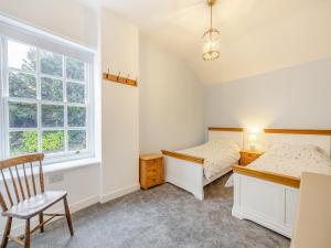 a bedroom with two beds and a window at Misdale House in Louth