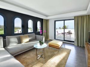 a living room with a couch and a table at Pullman Mazagan Royal Golf & Spa in El Jadida