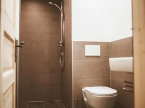 a bathroom with a toilet and a shower at Stockachhof in Fügenberg +63 photos