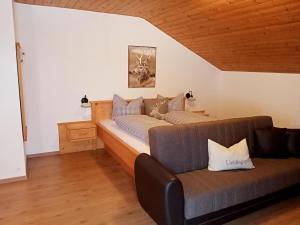 a living room with a couch and a bed at Stockachhof in Fügenberg