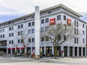 a white building with a bus sign on it at ibis Baar Zug in Zug