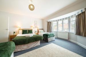 a hotel room with two beds and a window at Lelola Lodge in Bournemouth