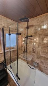 a bathroom with a shower and a tub at Haus Harmonie in Kaltenbach +52 photos