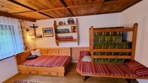 a room with a bed and a shelf with wine bottles at Haus Harmonie in Kaltenbach