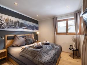 a bedroom with a bed with two towels on it at Appartement Krismer in Fügen