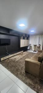 a living room with a couch and a table at Casa confortável para o são joão in Campina Grande