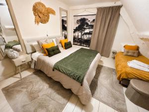 a bedroom with a bed with yellow and green pillows at Domaine VALENQUERCY in Cazillac +45 photos