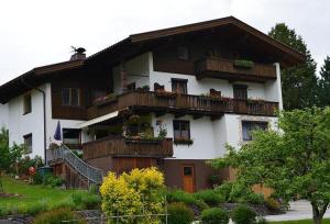 a large house with balconies and flowers on it at Ferienwohnung Garber in Uderns