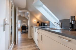 a kitchen with a sink and a counter top at Pier17 Appartement 6 in Borkum