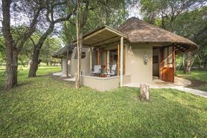 a small house with a thatched roof at Nyala Safari Lodge in Hoedspruit
