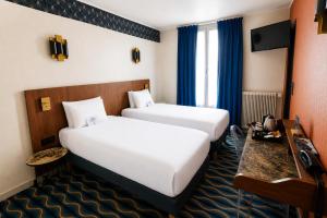 a hotel room with two beds and a television at Kyriad Hotel XIII Italie Gobelins in Paris