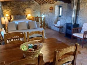 a bedroom with a bed and a table in a room at Horizontes Serranos in Tondela