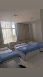 a bedroom with two beds and a window at Bellonorte Hotel in Altamira