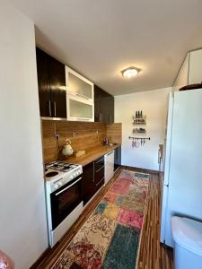 a kitchen with a stove and a refrigerator at Golden Apartment in Travnik
