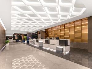 a lobby of a hotel with a reception desk at Novotel Atlantis Shanghai in Shanghai