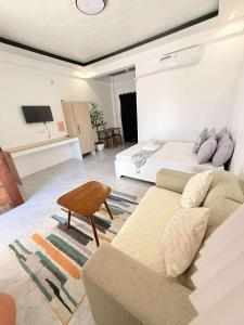 a living room with a couch and a bed at Reynaldos Place Corporation in Vigan