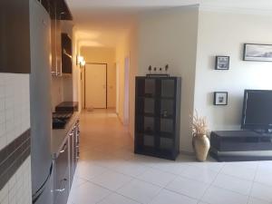 a kitchen with a black cabinet in a room at Familja Kapaj in Polisi i Vogël