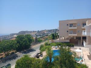 a view from the balcony of a building with a swimming pool at Seaview Holiday Studio Peyia in Peyia
