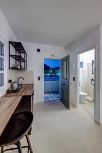 a bathroom with a sink and a toilet and a door at Βlue Lagoon G6 in Galissas +42 photos