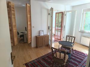 a room with a table and chairs and a desk at Pine Breeze in Punat