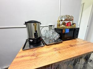 a coffee maker on a counter next to a microwave at Like House Karakol in Karakol