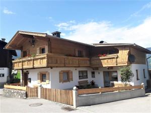 a wooden house with a balcony on top of it at Jagerhäusl in Fügen