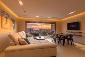 a living room with a couch and a table at Ocean & Sunset View Pool & Parking in Tamraght Ouzdar