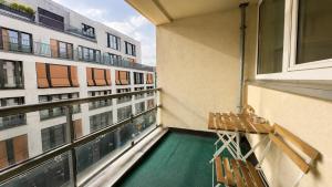 a balcony with chairs and a swimming pool on a building at URBAN FLATS Berlin in Berlin