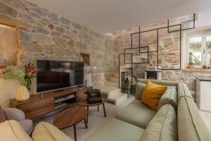 a living room with a stone wall at Villa Pauletta in Split
