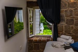 a room with a window and a couch with towels at Villa Pauletta in Split +47 photos
