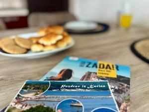 a book sitting on a table with a plate of food at Cozy apartment Ivana in Gornji Karin +9 photos