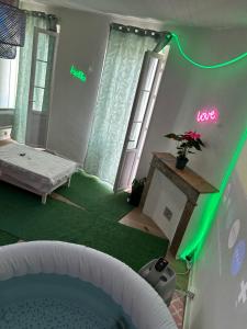 a room with a bed and a room with green lights at Un Jacuzzi dans le centre in Bordeaux +7 photos