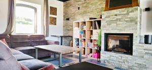 a living room with a couch and a fireplace at Durbuy House in Durbuy