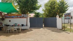 a patio with a table and chairs in front of a building at GTR Royal Palace cottage in Wodapatti