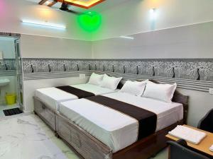 a bedroom with a large bed in a room at GTR Royal Palace cottage in Wodapatti