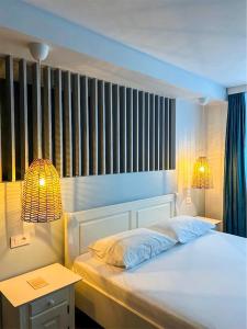 a bedroom with a bed and a table and two lamps at La Cupric in Sarichioi