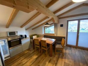 a kitchen with a table and chairs in a room at Ferienwohnung Garber in Uderns