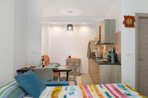 a room with a kitchen with a table and a bed at Quercia -in Caruggiu di Via Vecchia in Orco Feglino