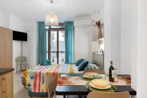 a bedroom with a bed and a table with plates on it at Quercia -in Caruggiu di Via Vecchia in Orco Feglino +14 photos