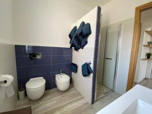a bathroom with a toilet and a sink and a shower at R House II - Puntocasabudoni in Budoni +37 photos