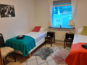 a bedroom with two beds and a window at Guesthouse in Ólafsvík
